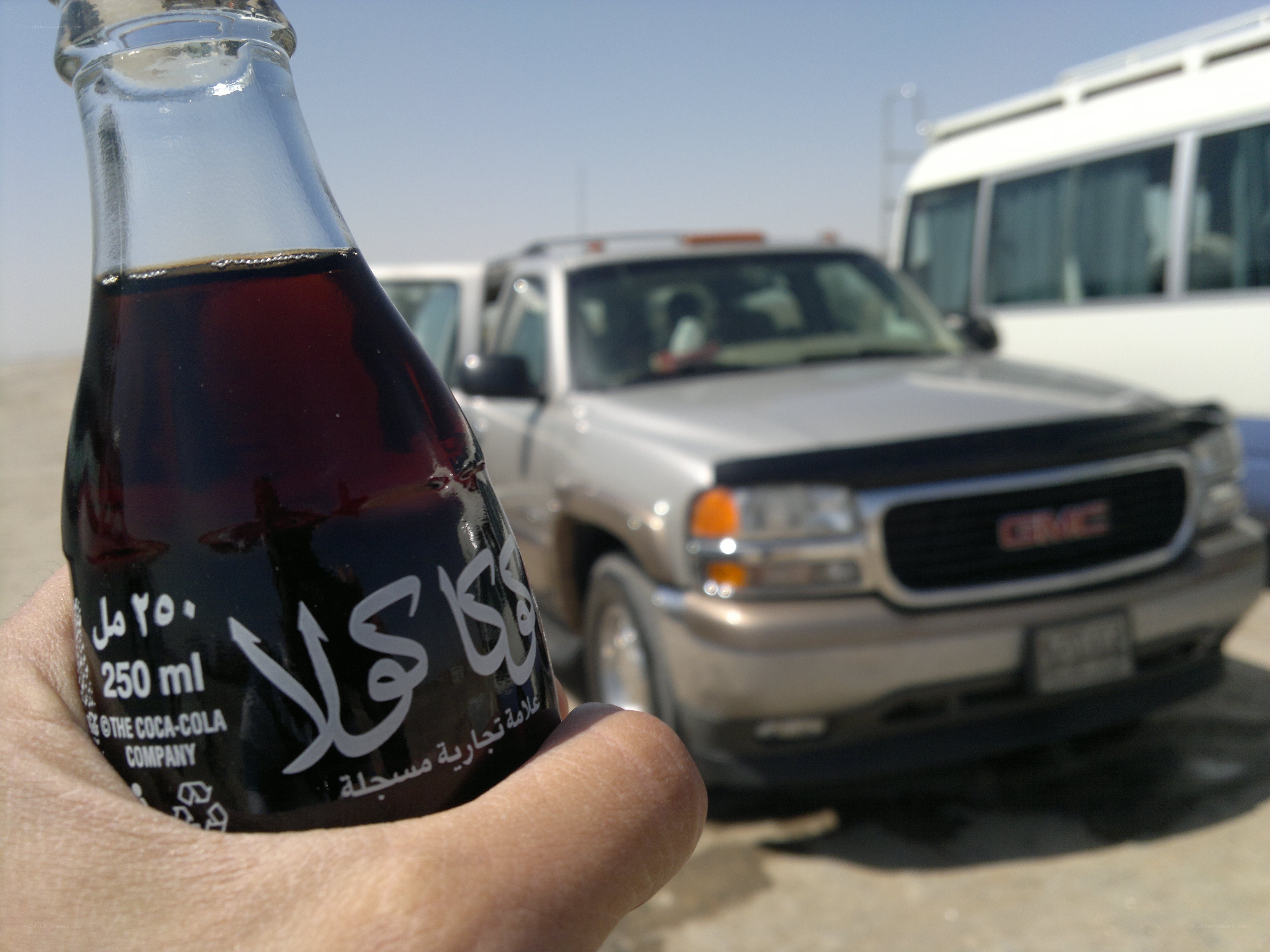 Coca-Cola bottle in desert