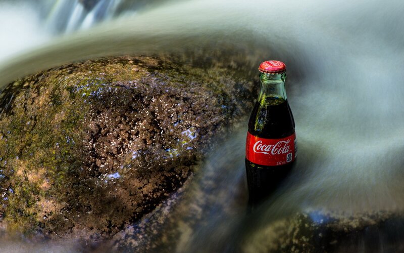 Coca-Cola Bottle in Stream — Brown, Serene