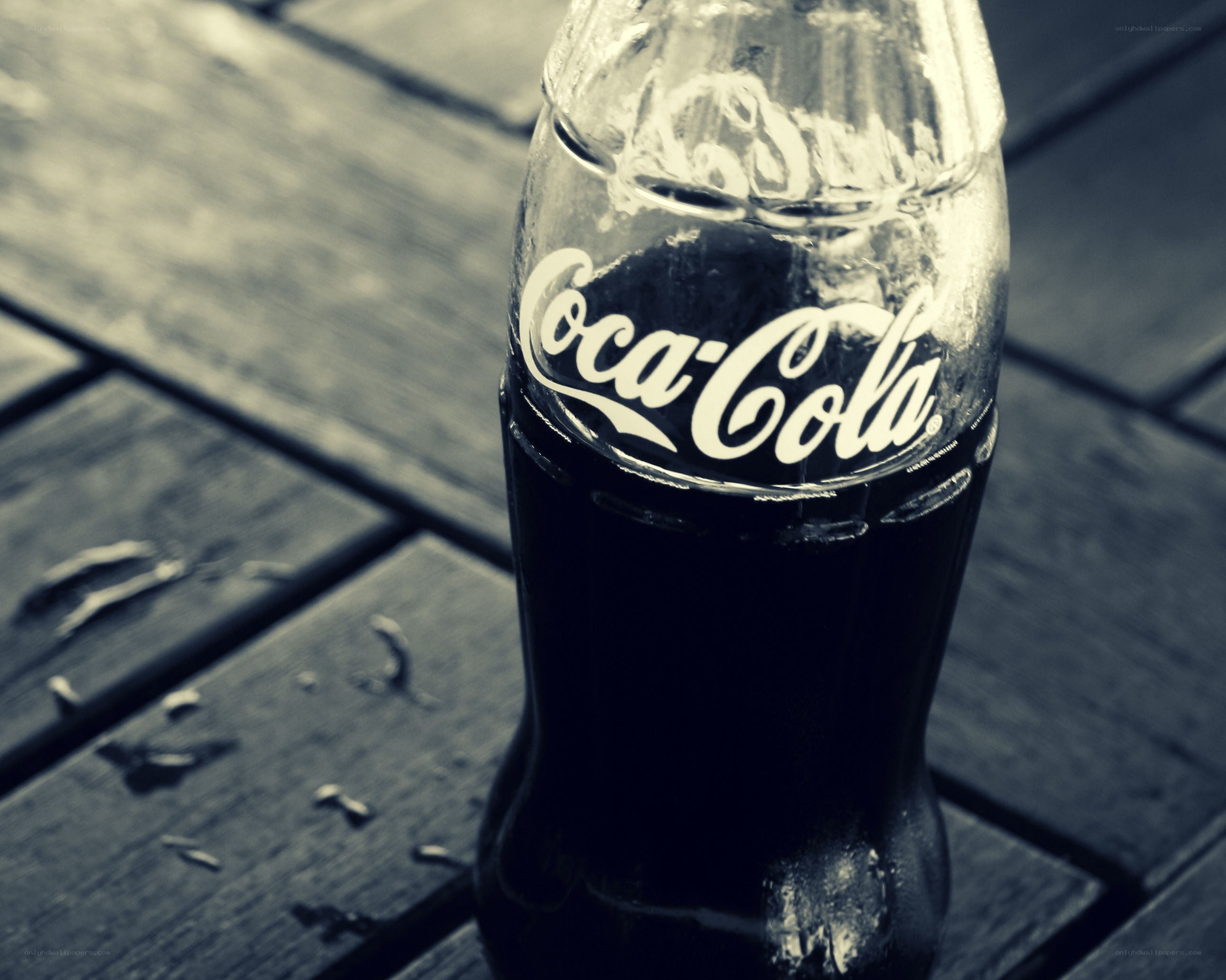 Coca-Cola bottle on wooden surface