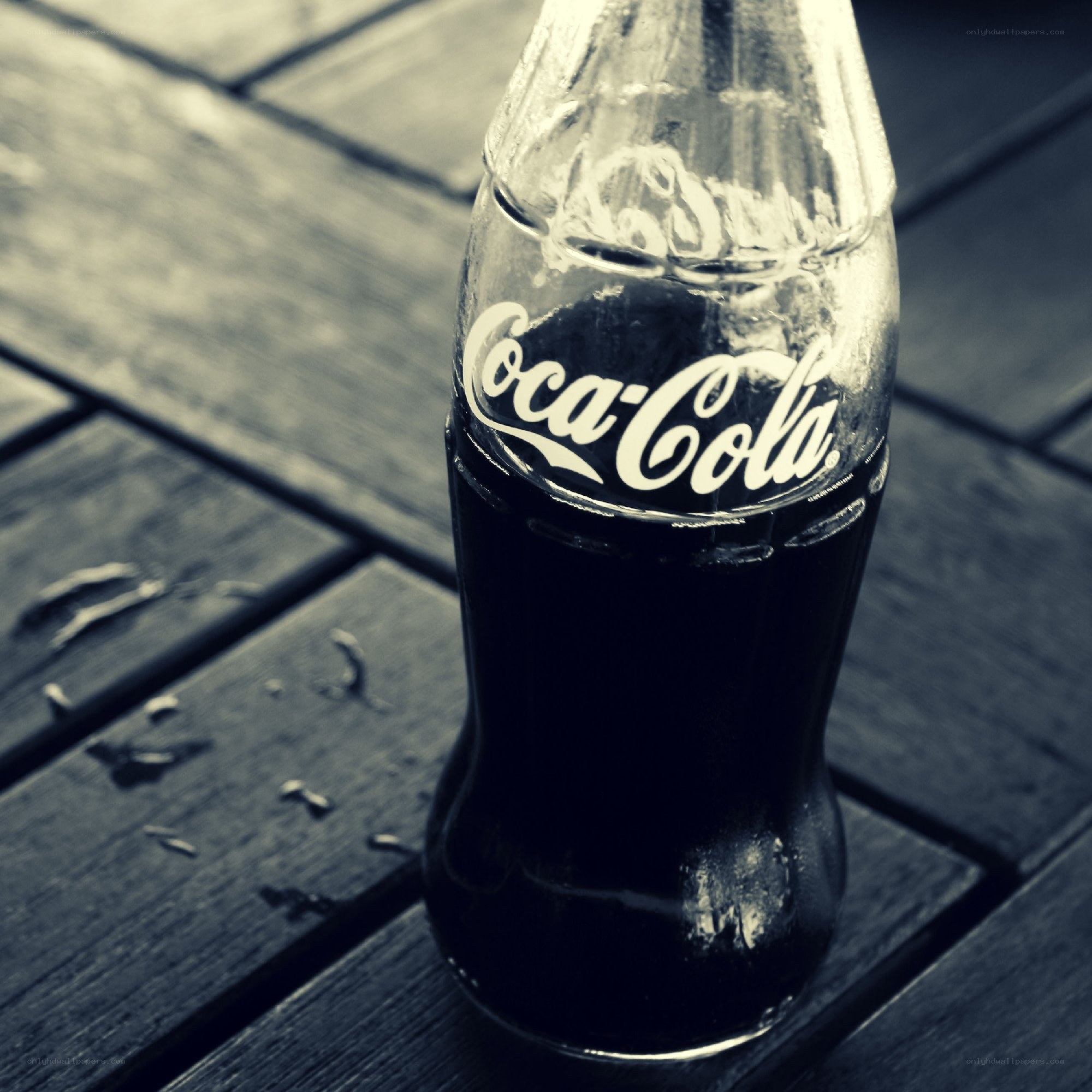 Coca-Cola bottle on wooden table