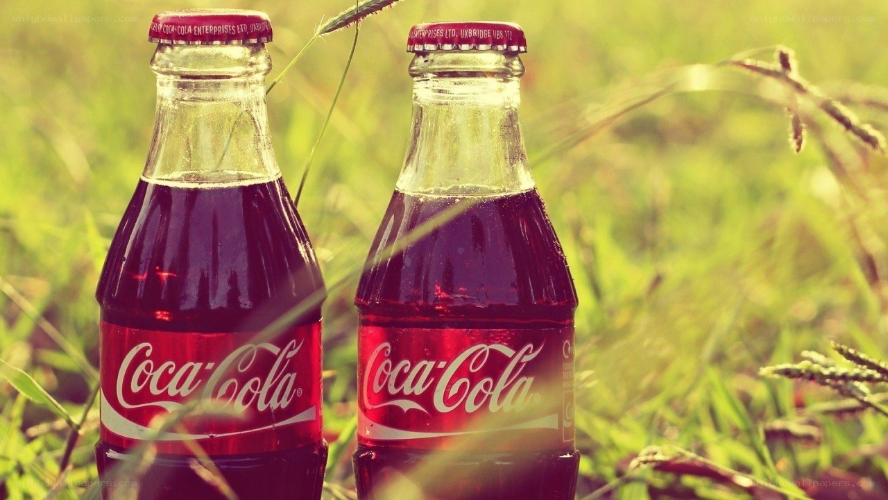 Coca-Cola bottles in grass