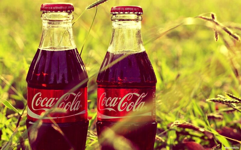 Coca-Cola bottles in grass