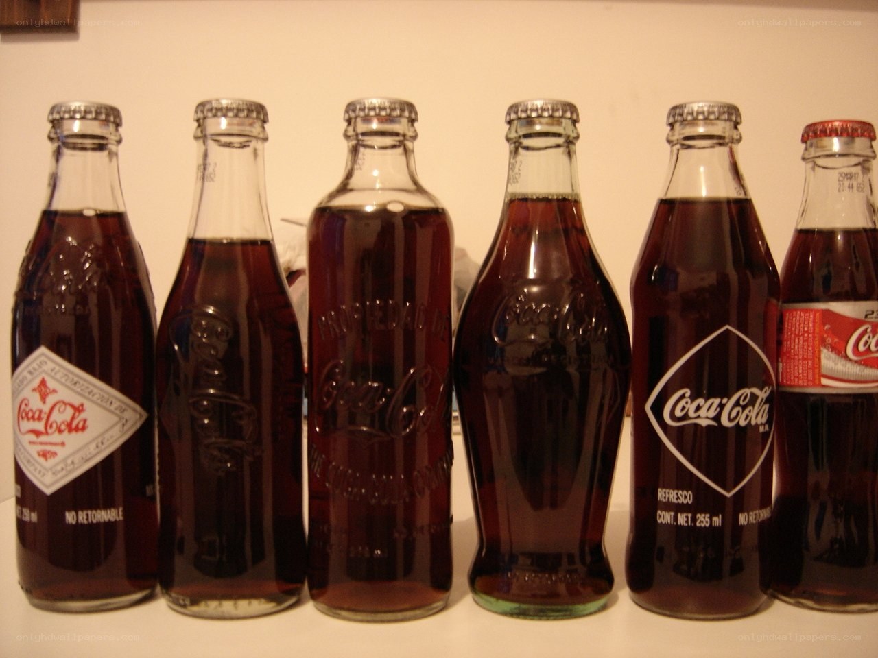 Coca-Cola bottles in various designs