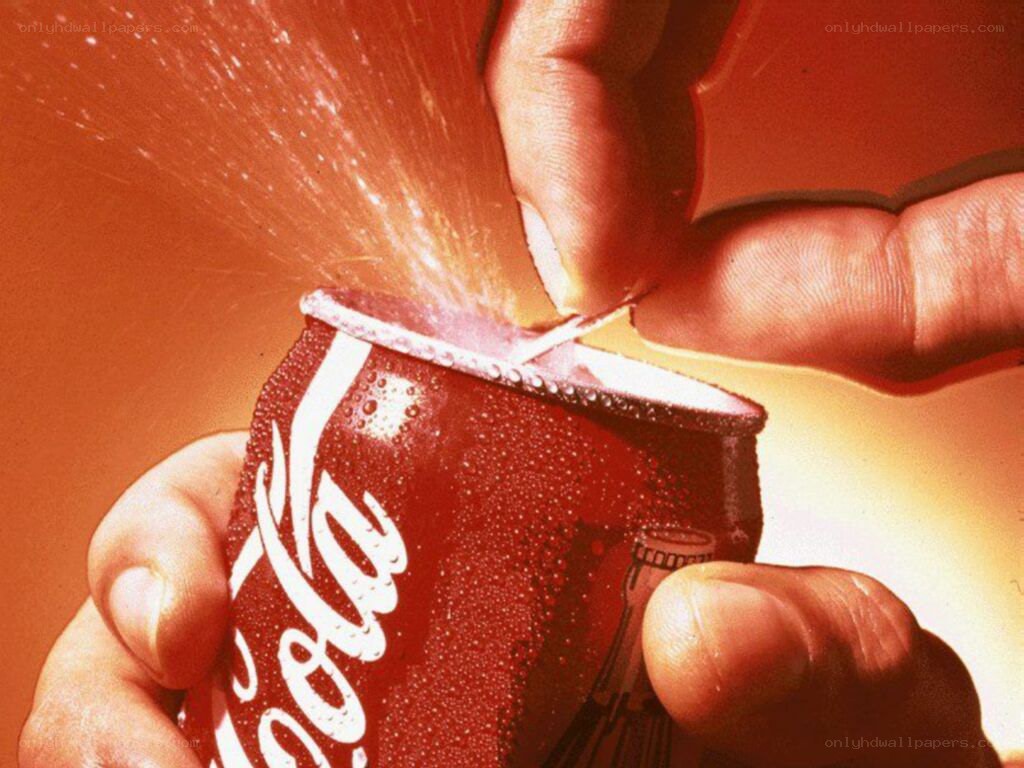 Coca-Cola can being opened