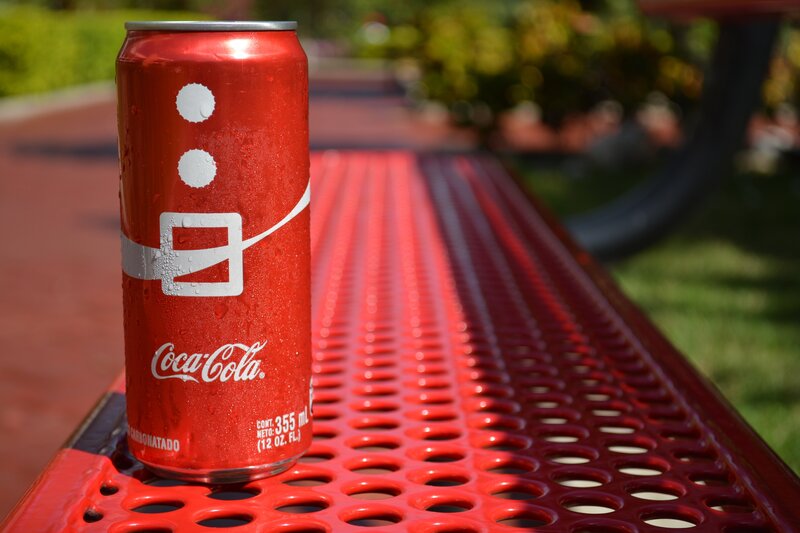 Coca-Cola can on red table
