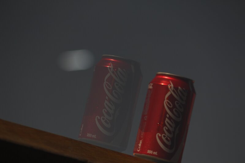Coca-Cola cans on a surface