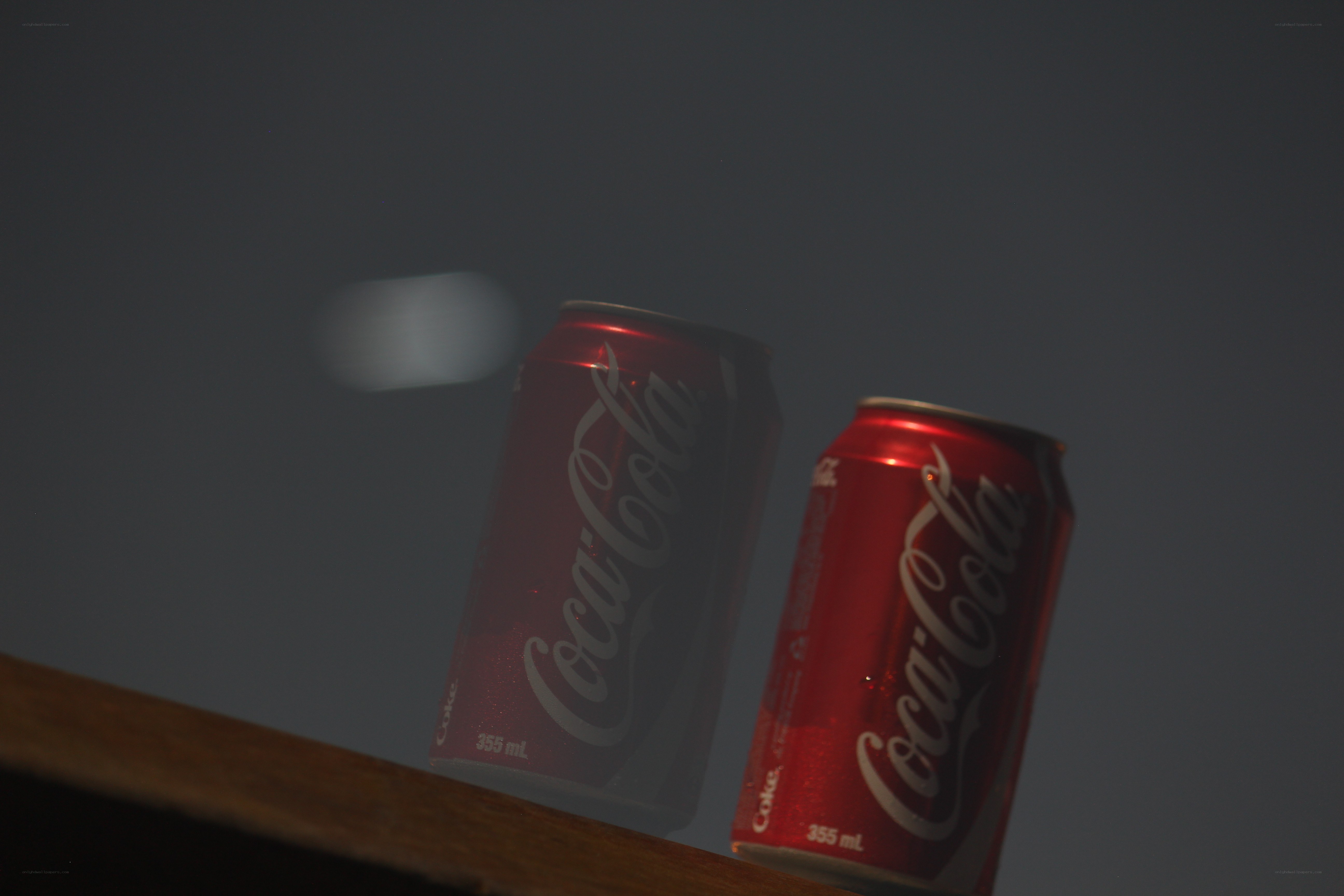 Coca-Cola cans on a surface