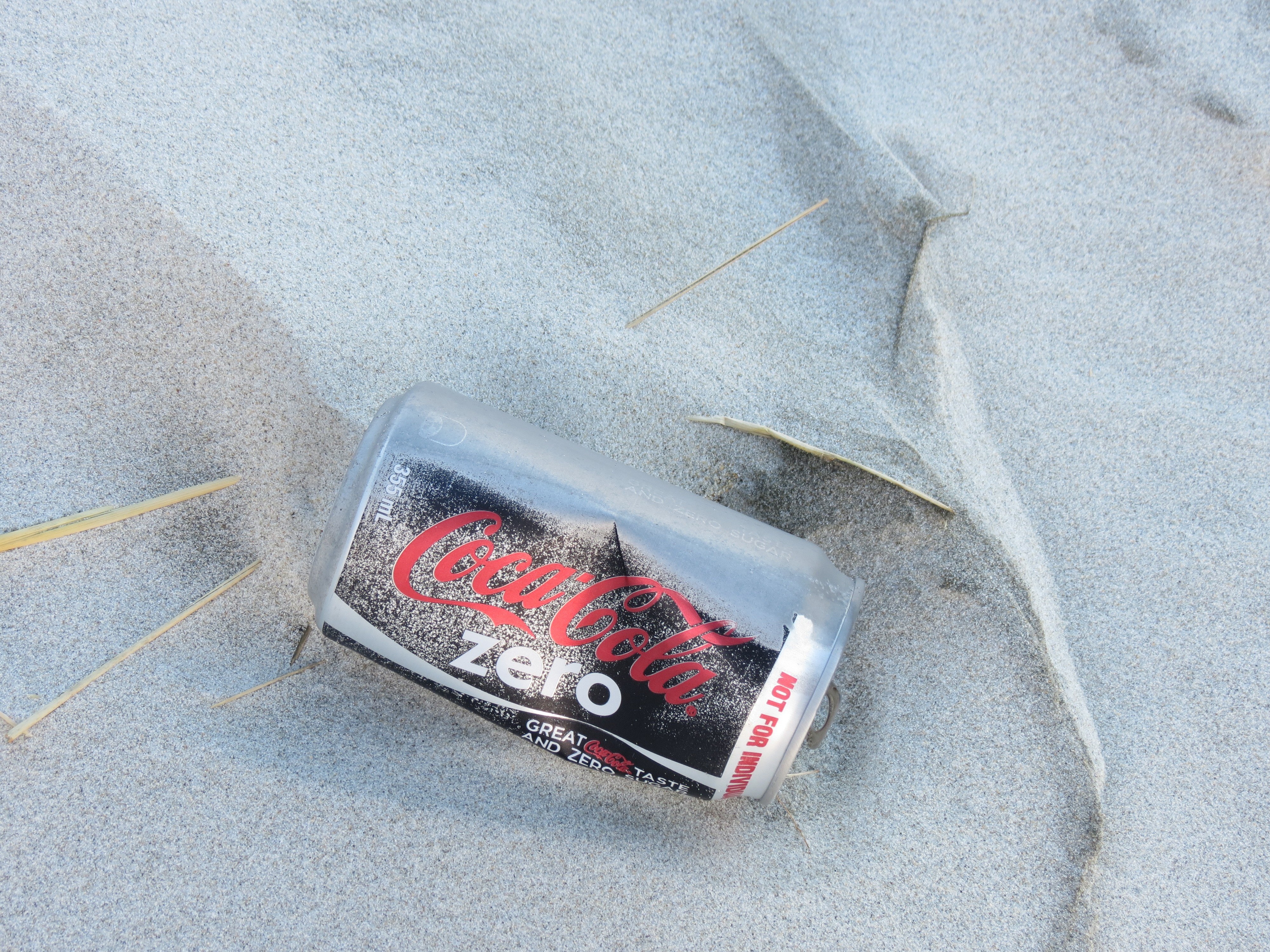 Coca-Cola Zero can on sand