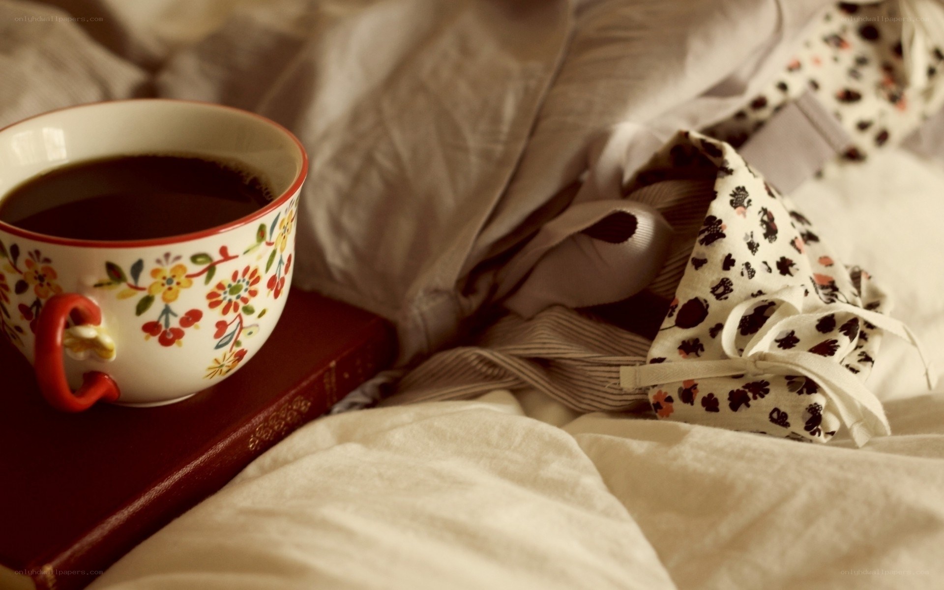 coffee and book on bed