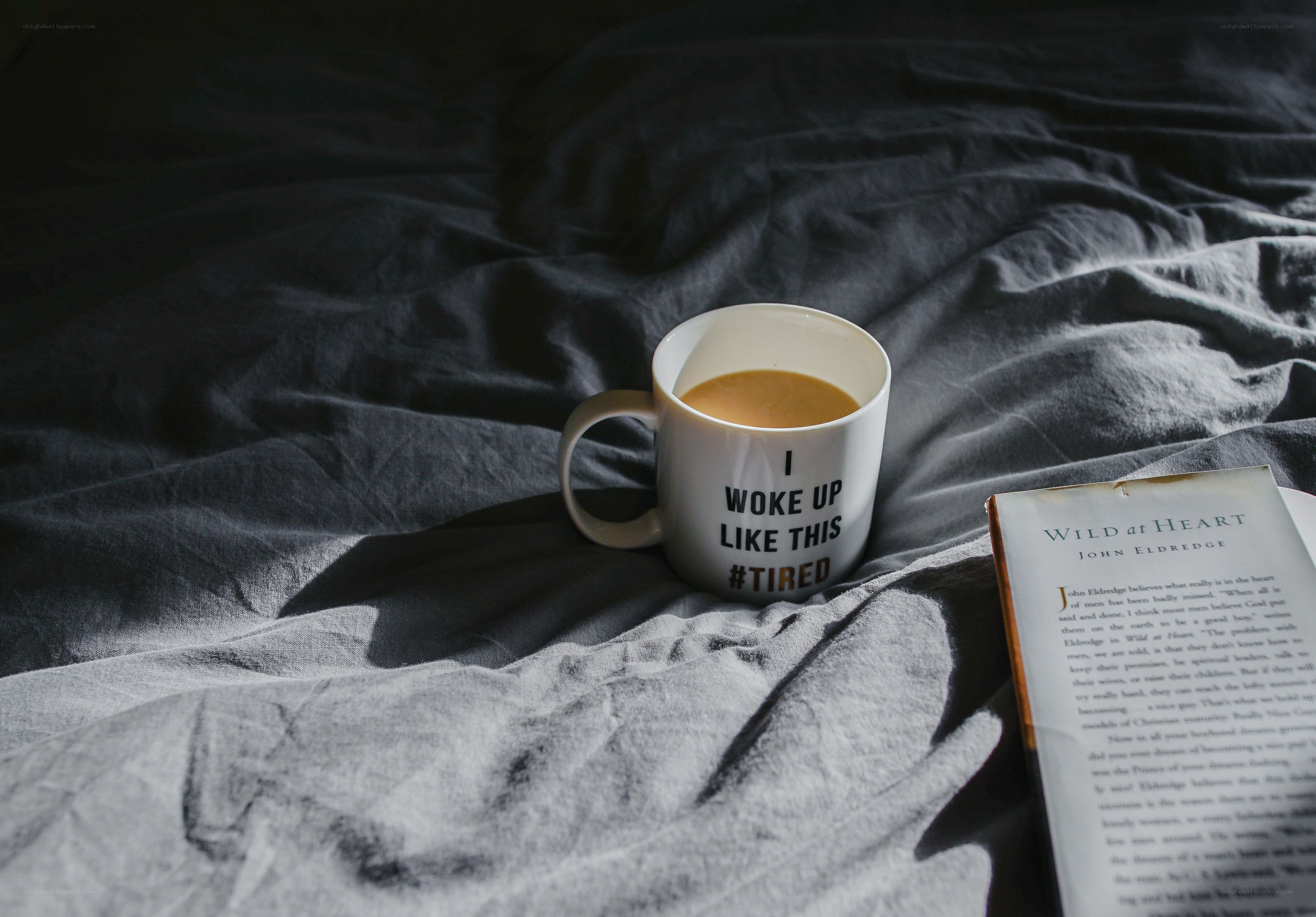 coffee and book on bed