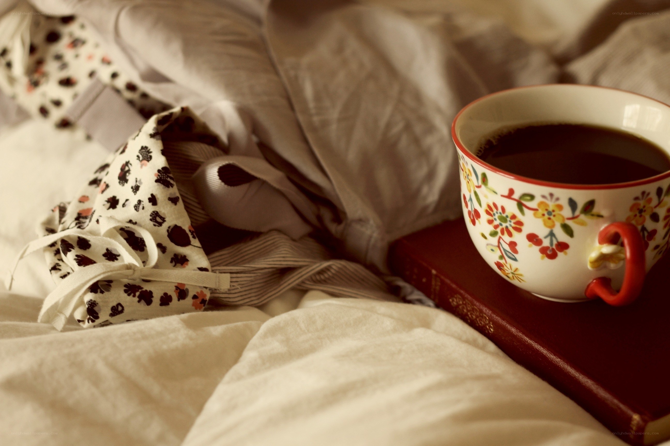 coffee and book on bed