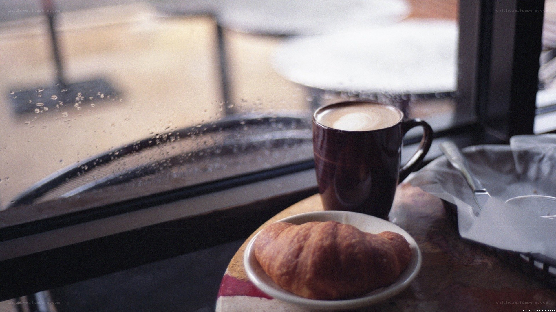 coffee and croissant by window