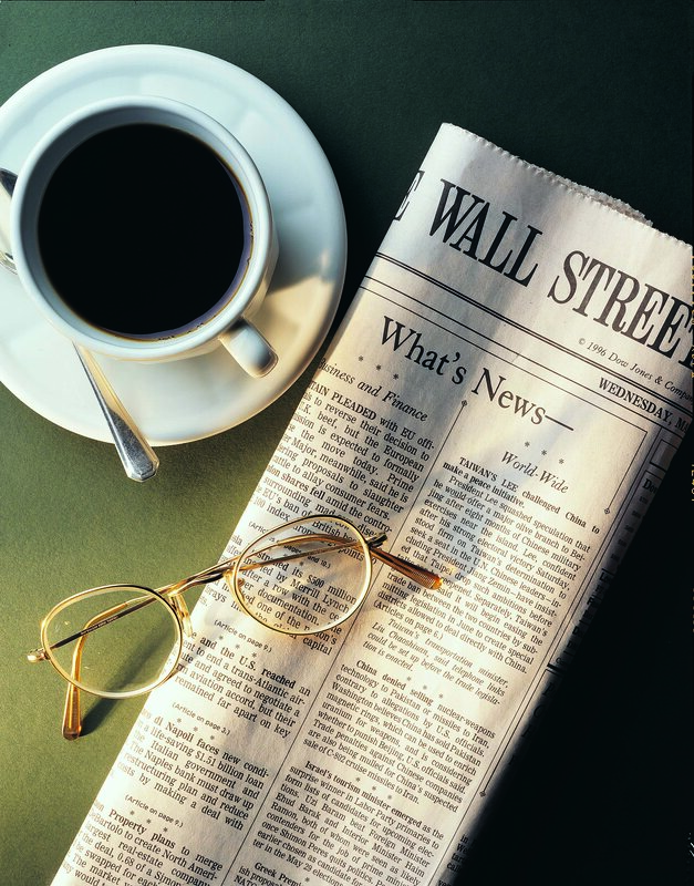 Coffee and newspaper on table