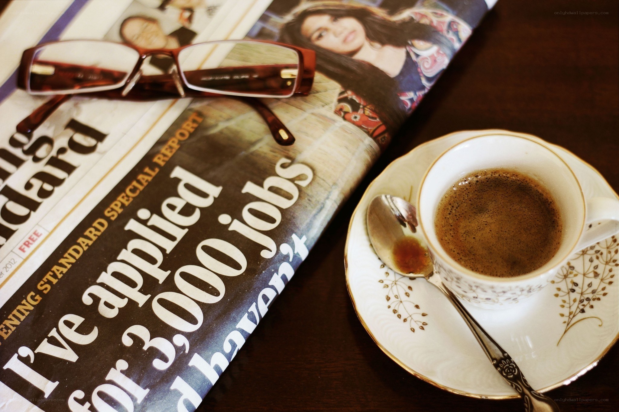 Coffee and newspaper on table