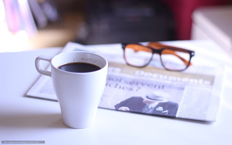 coffee and newspaper on table