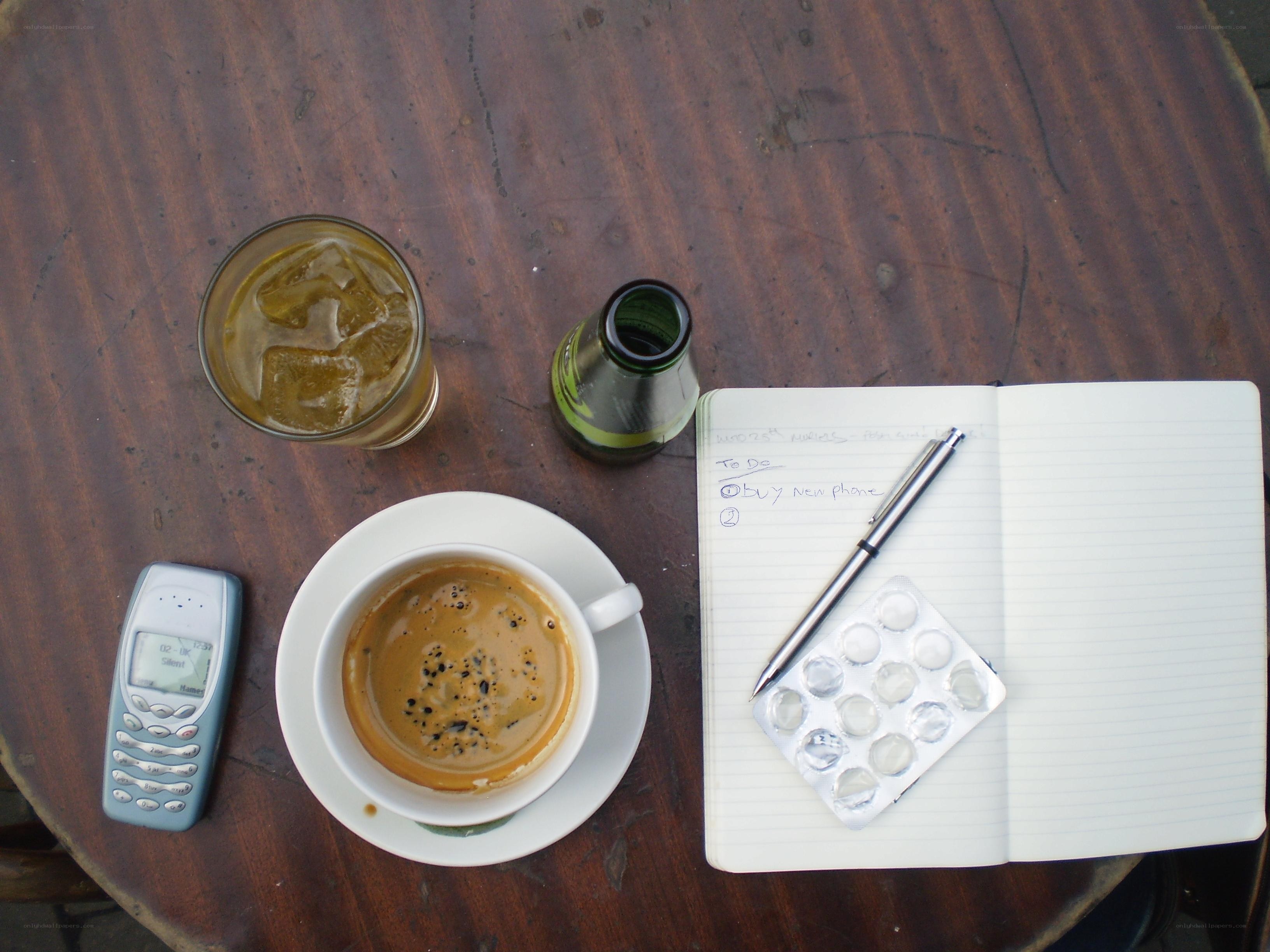 Coffee and notebook on a table