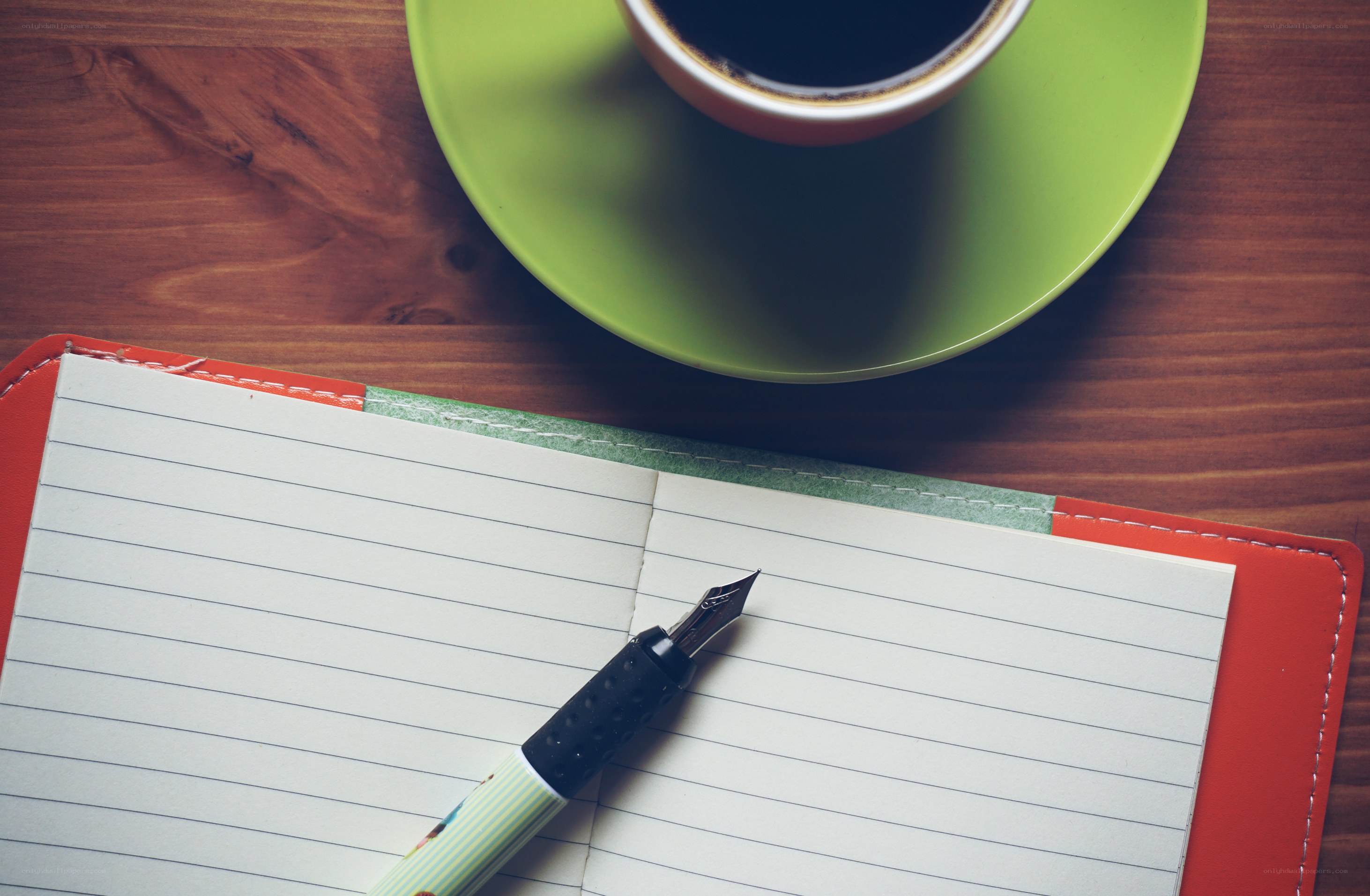 Coffee and notebook on wood