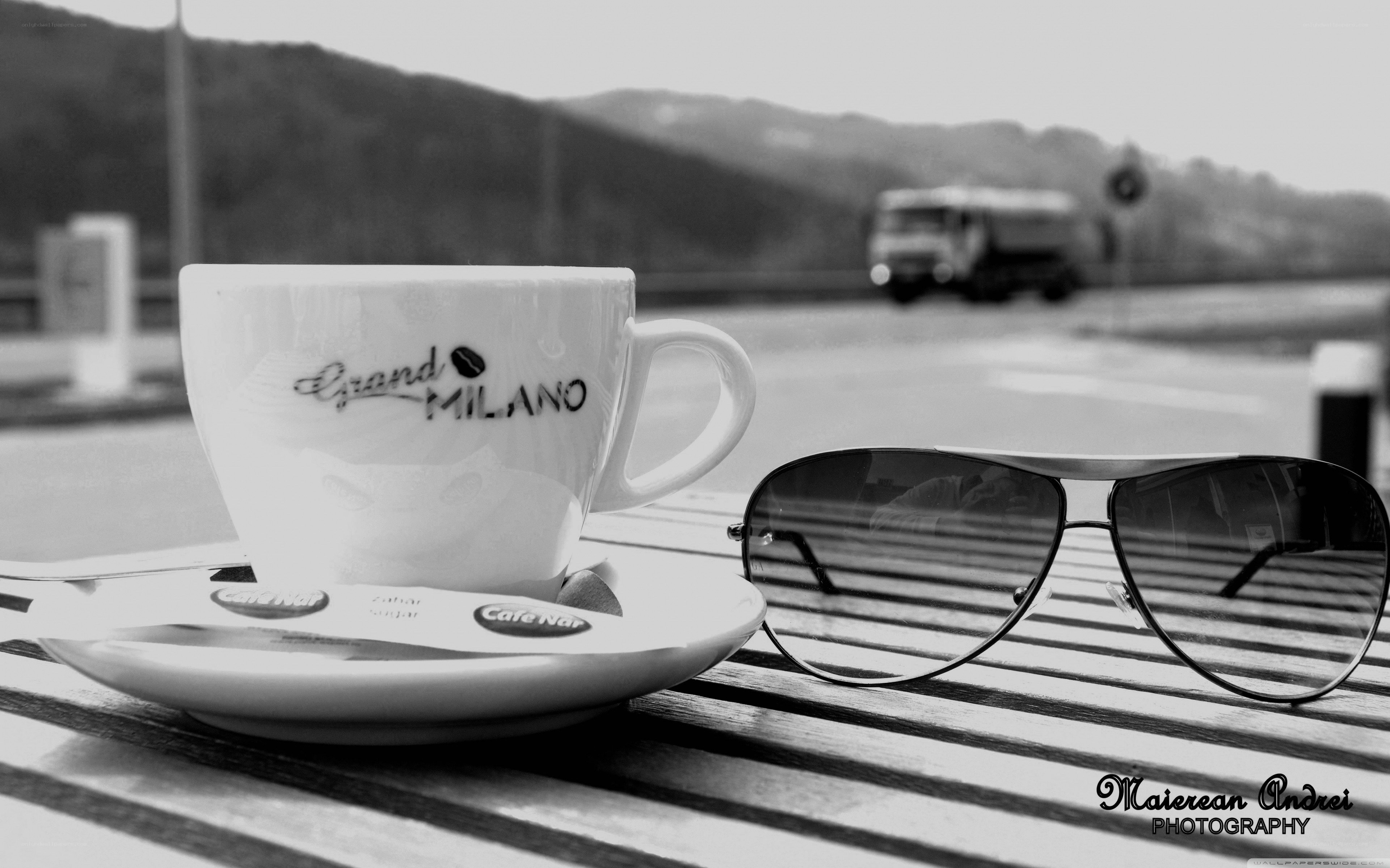 Coffee and sunglasses on a table