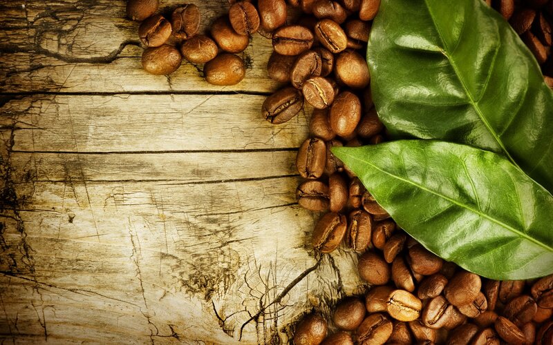 coffee beans and leaves on wood