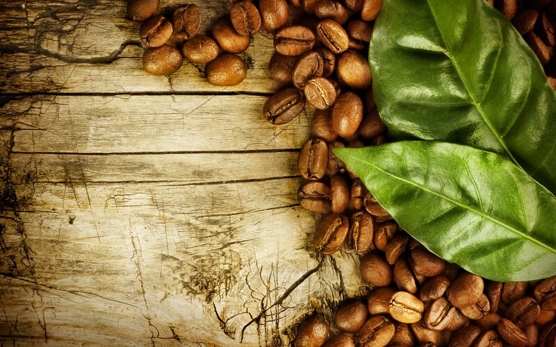 coffee beans and leaves on wood