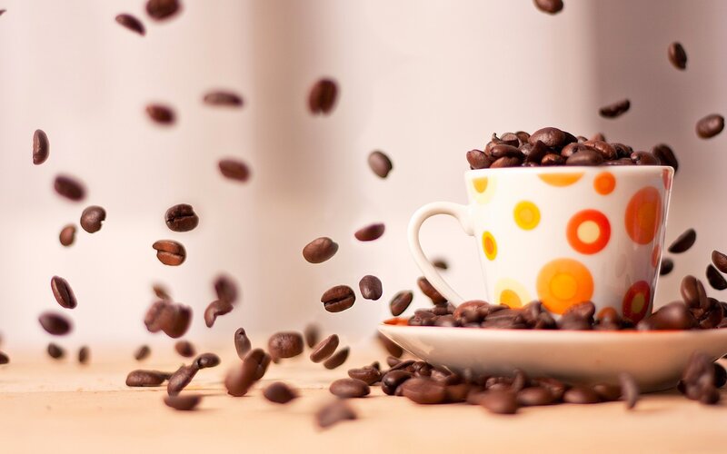 coffee beans falling into cup