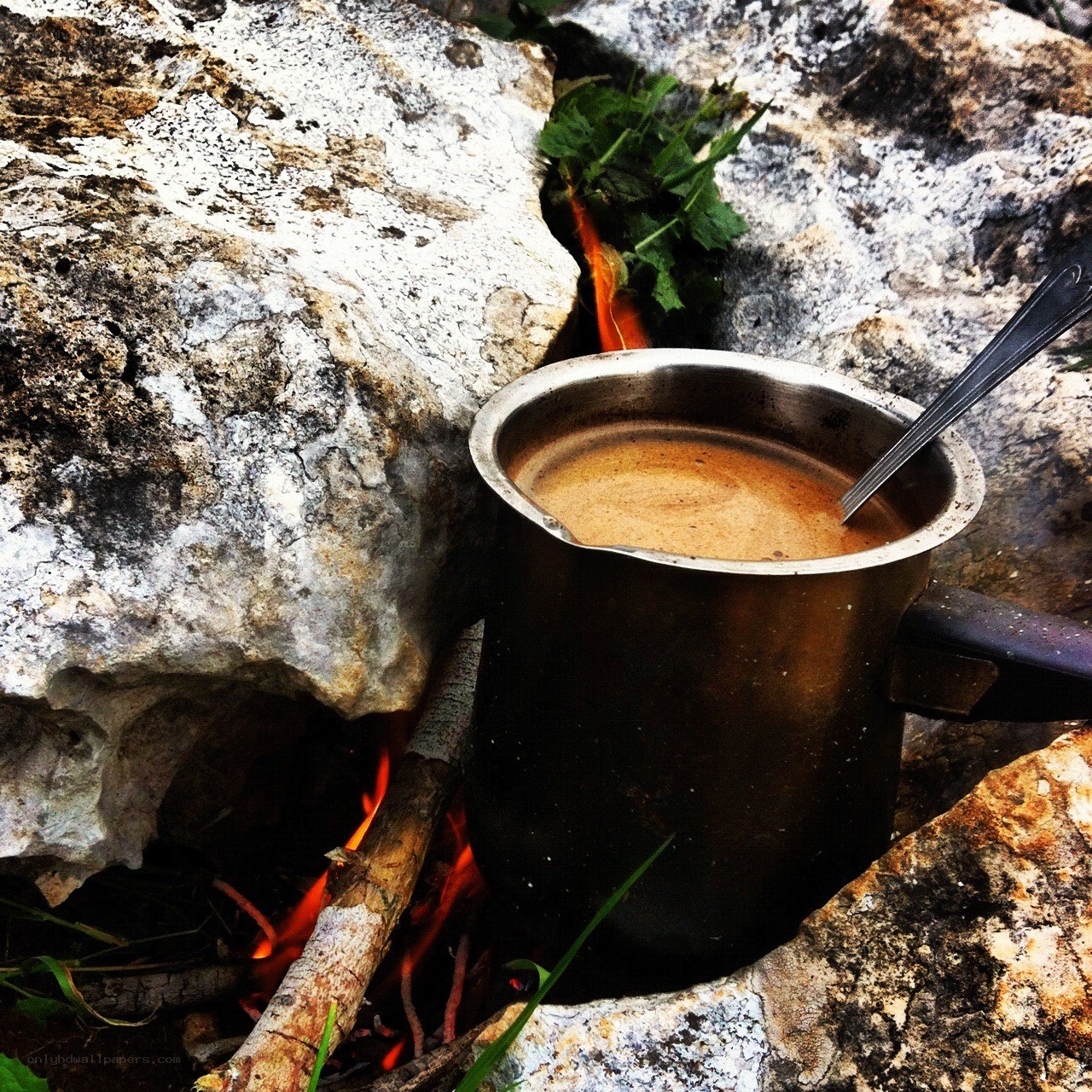 Coffee brewing over a campfire