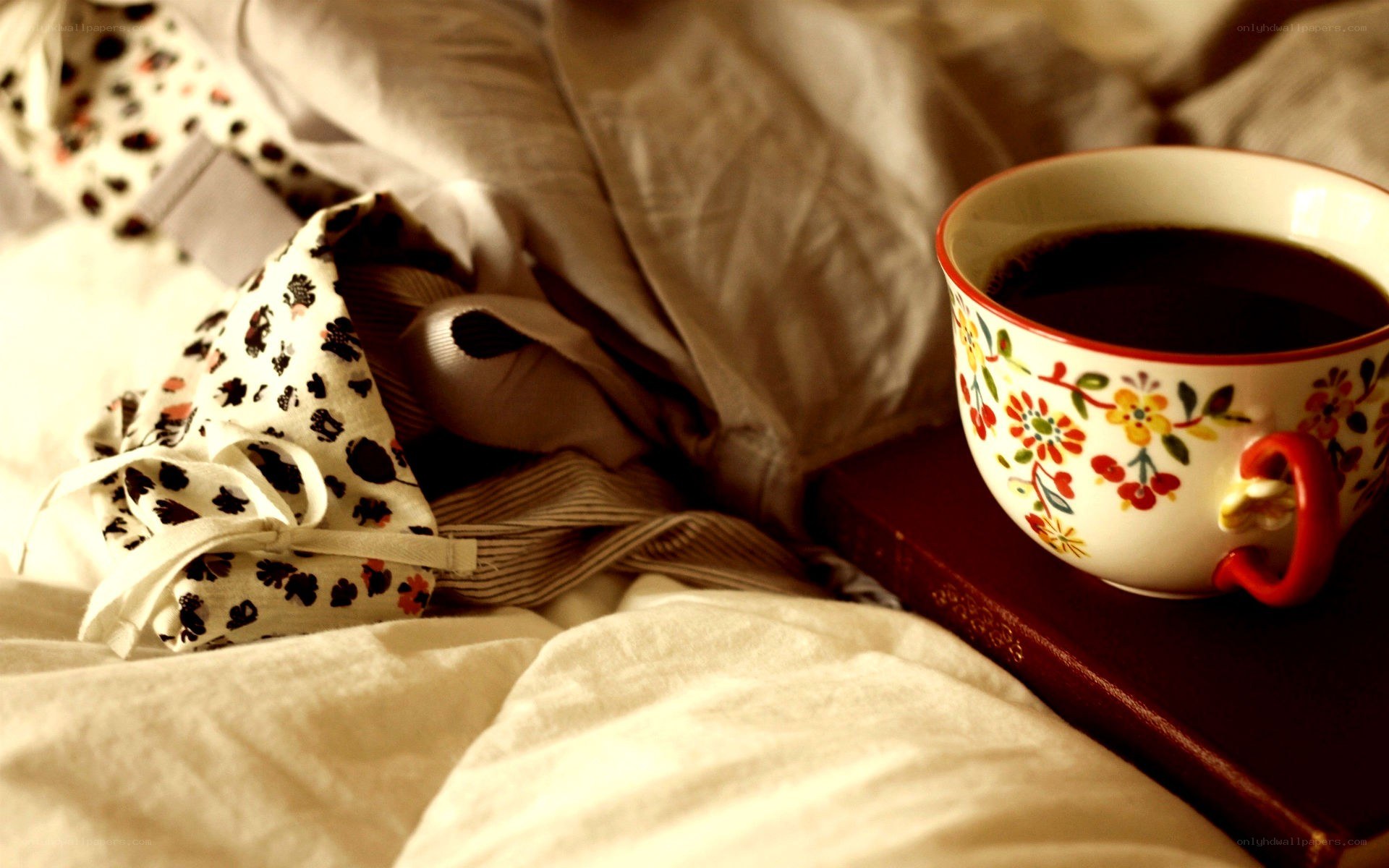 coffee cup on book in bed