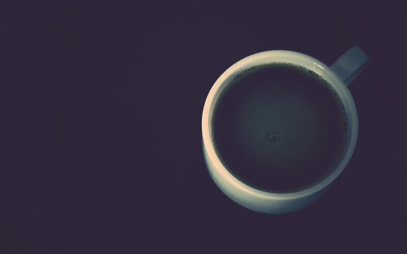 coffee cup on dark surface