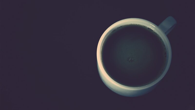 coffee cup on dark surface