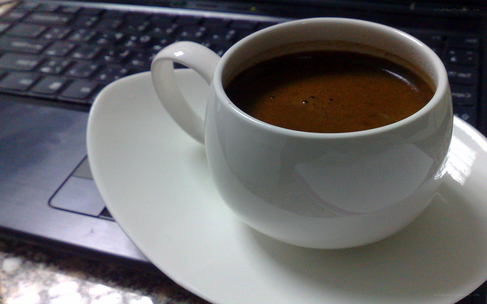 coffee cup on laptop