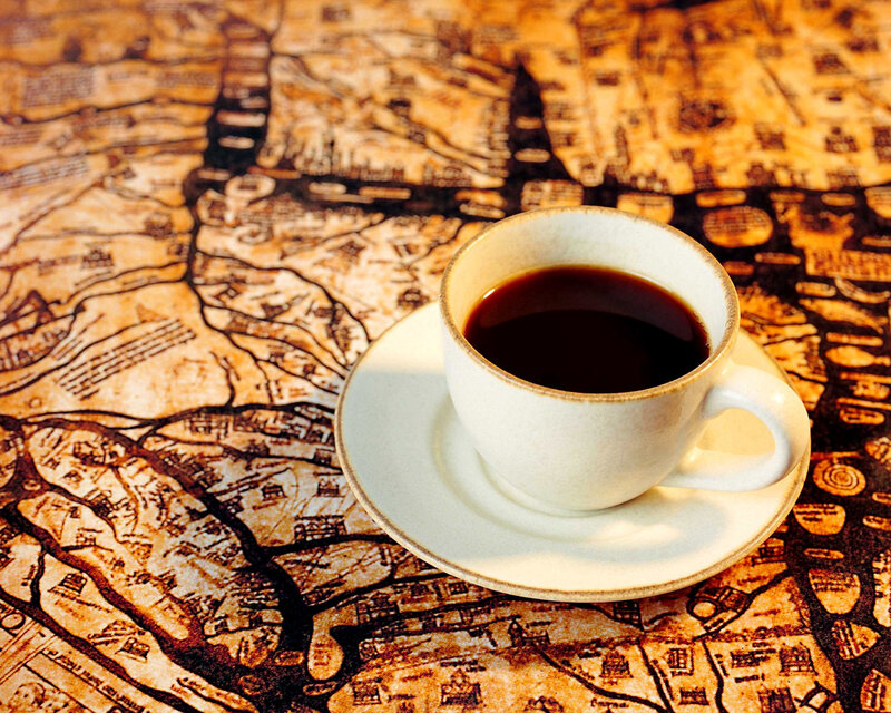 coffee cup on old map