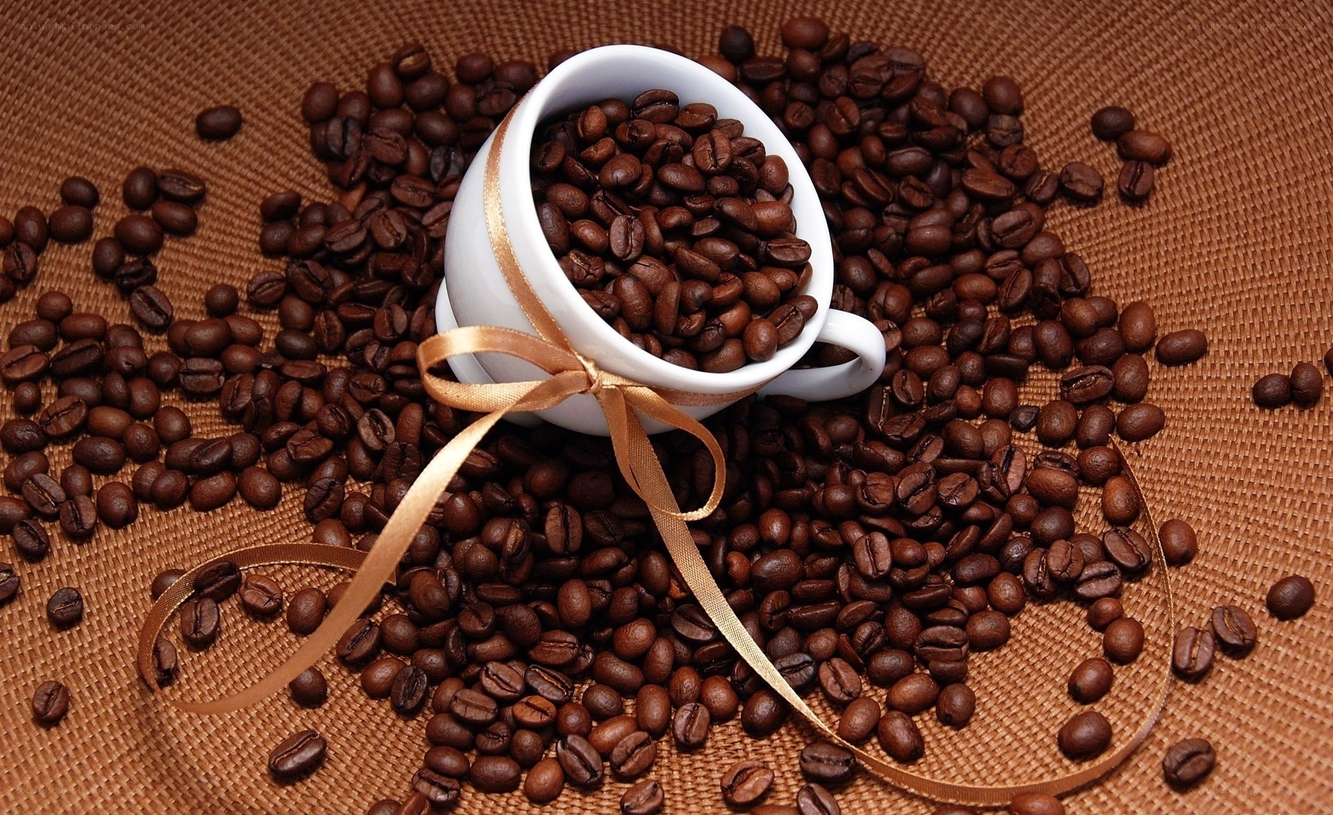 coffee cup with beans and ribbon