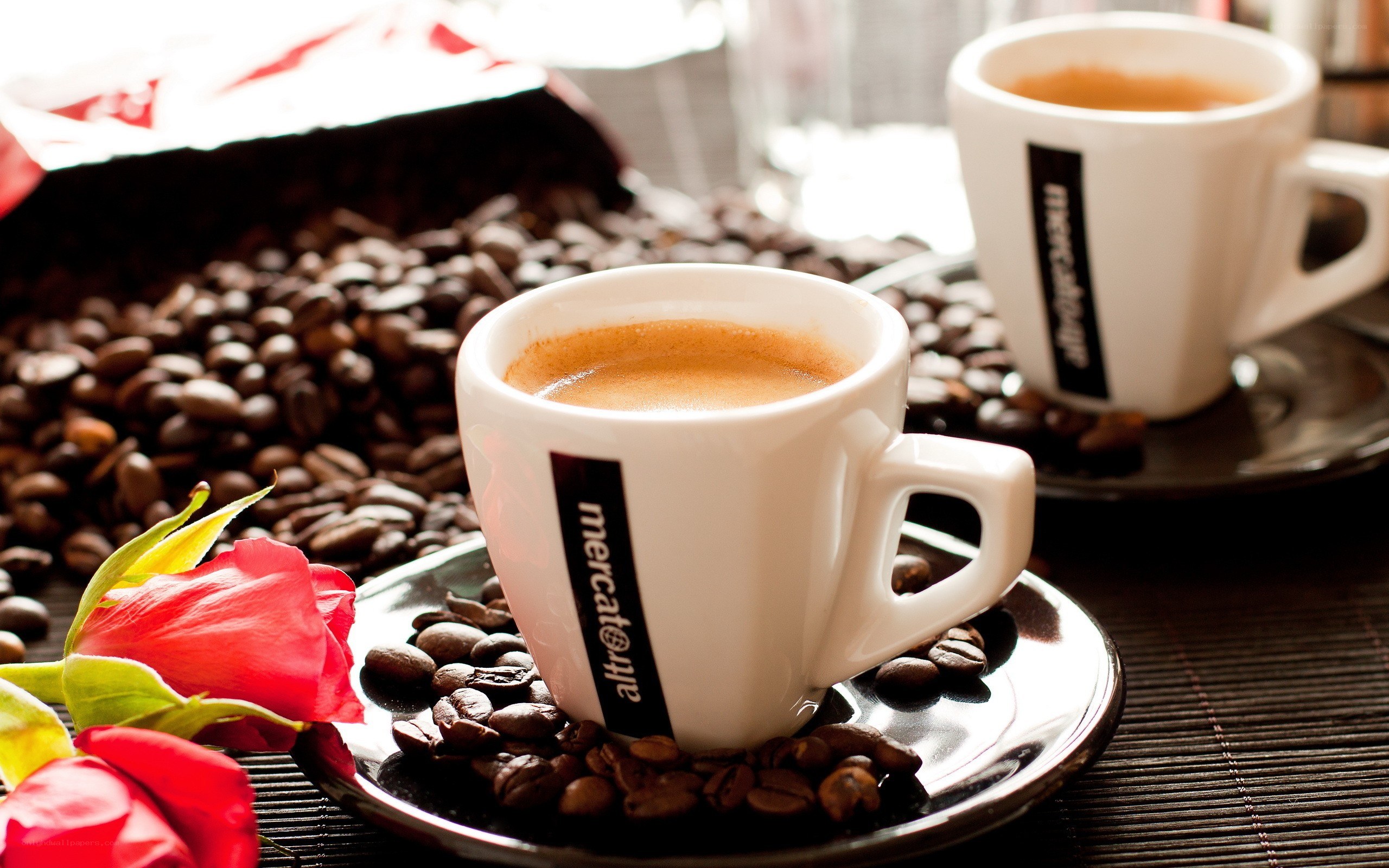 coffee cups with beans and rose