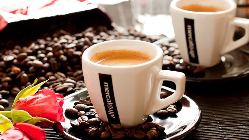 coffee cups with beans and rose