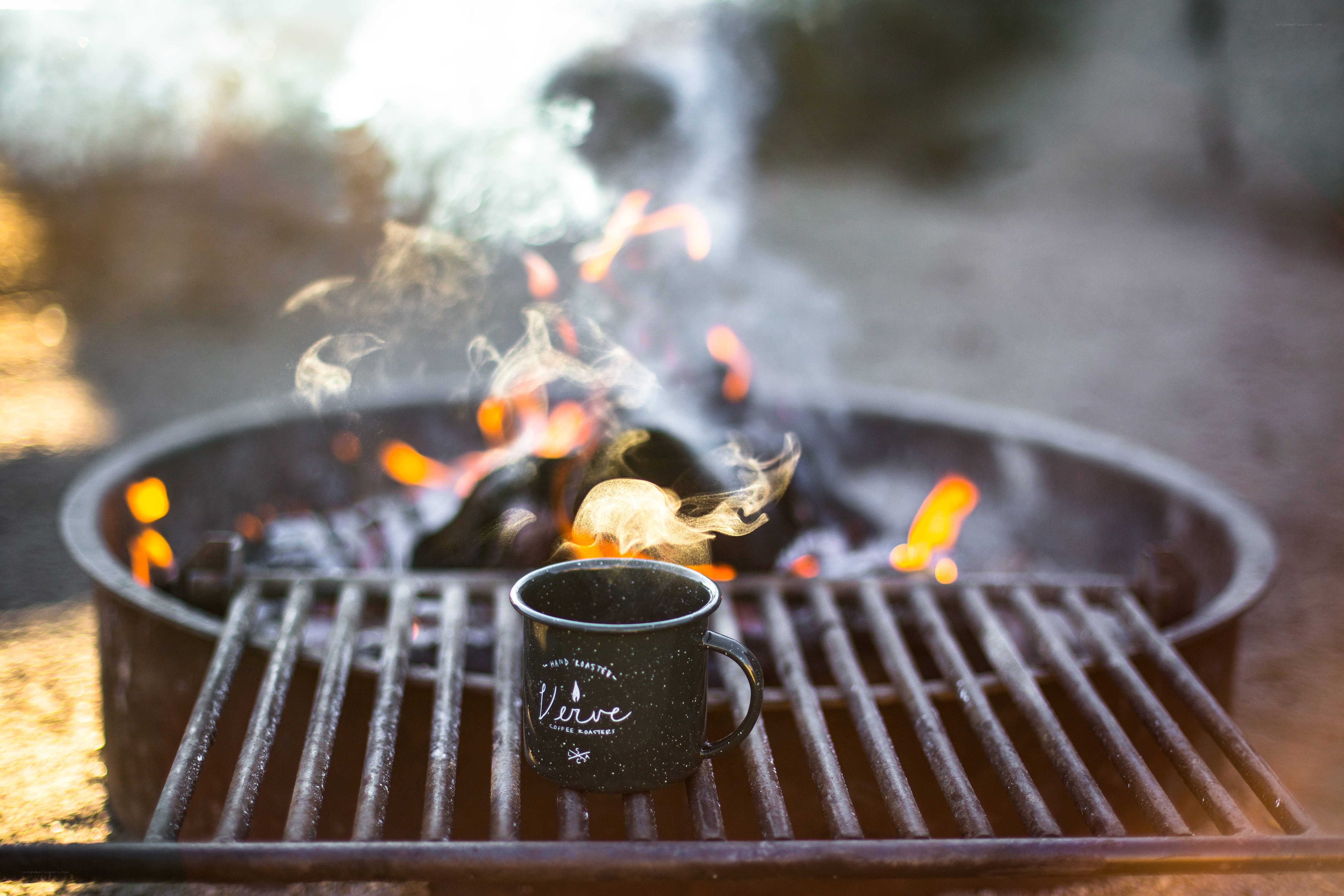 coffee mug by campfire