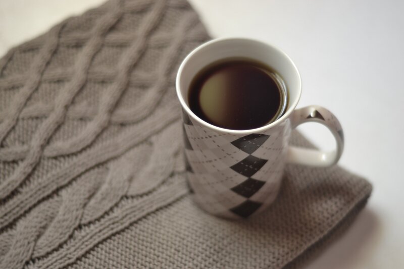 coffee mug on sweater