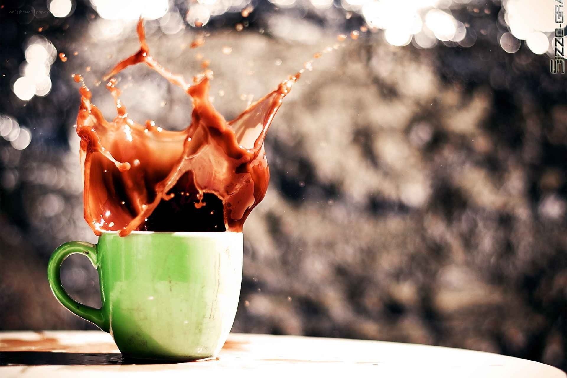 coffee splashing from a green cup