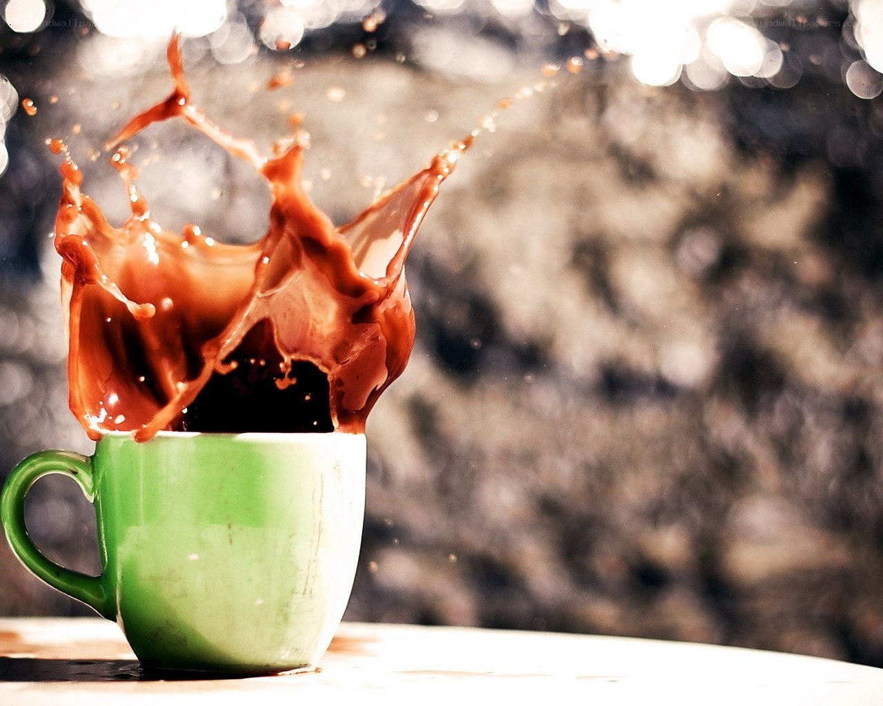 coffee splashing in green cup