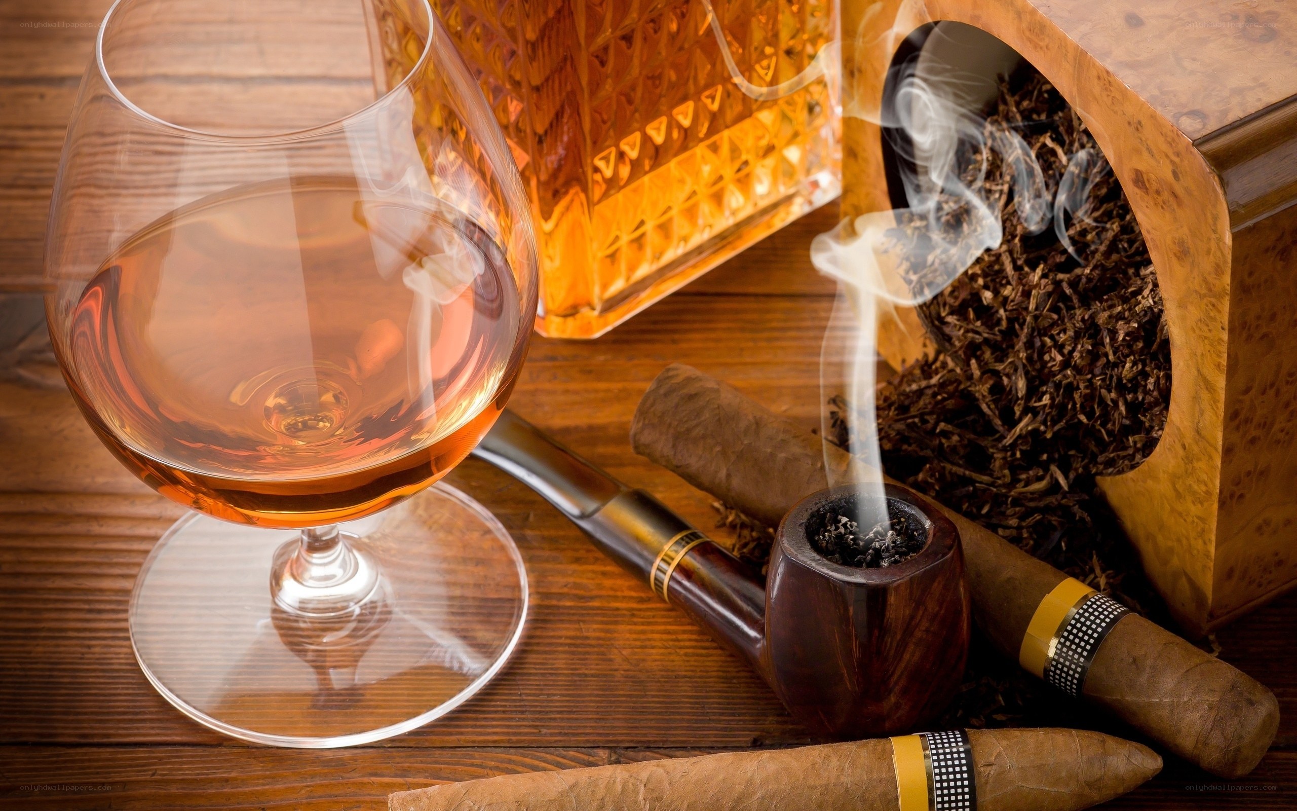 Cognac and cigars on wood