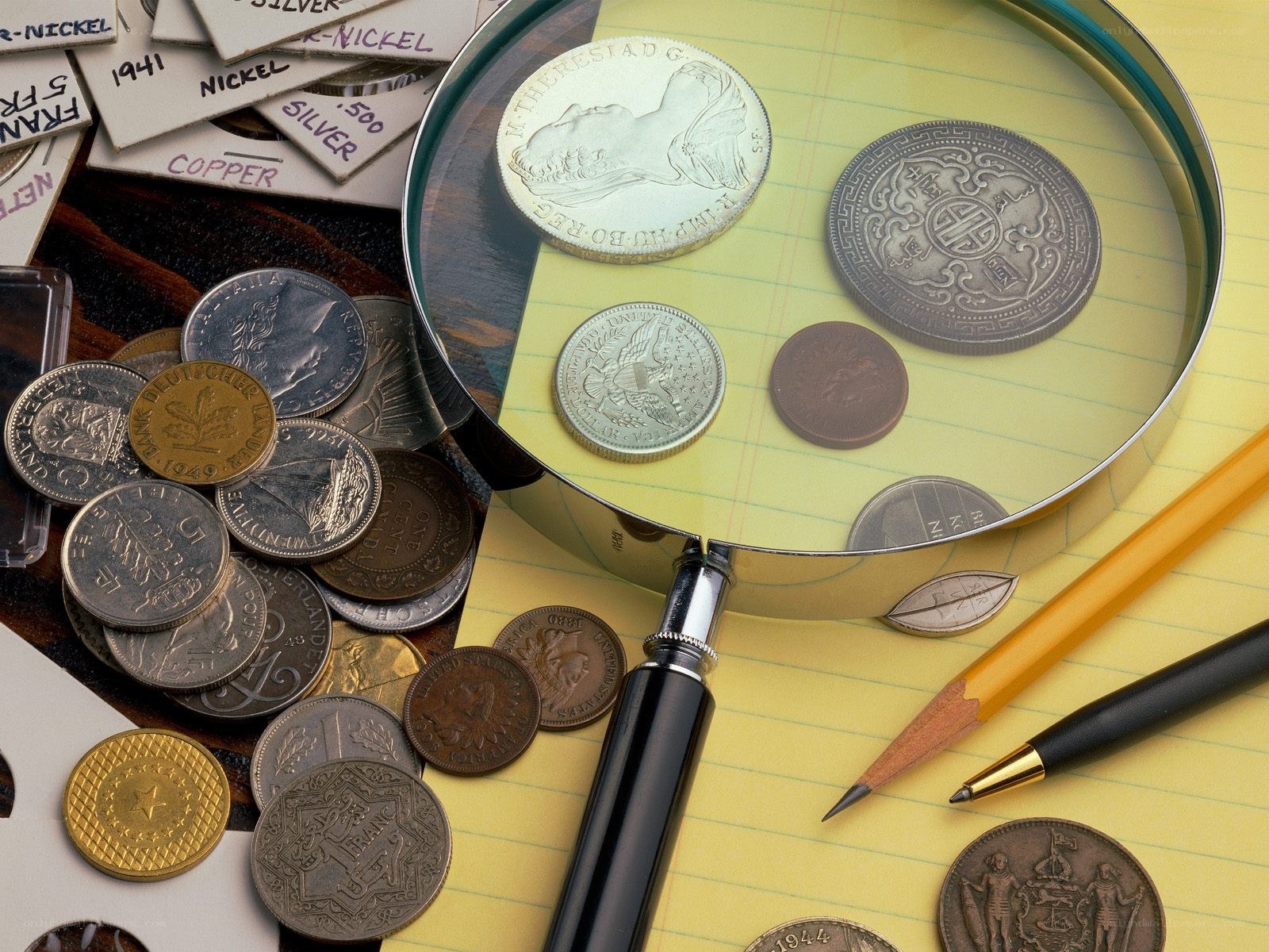 coin collection with magnifying glass
