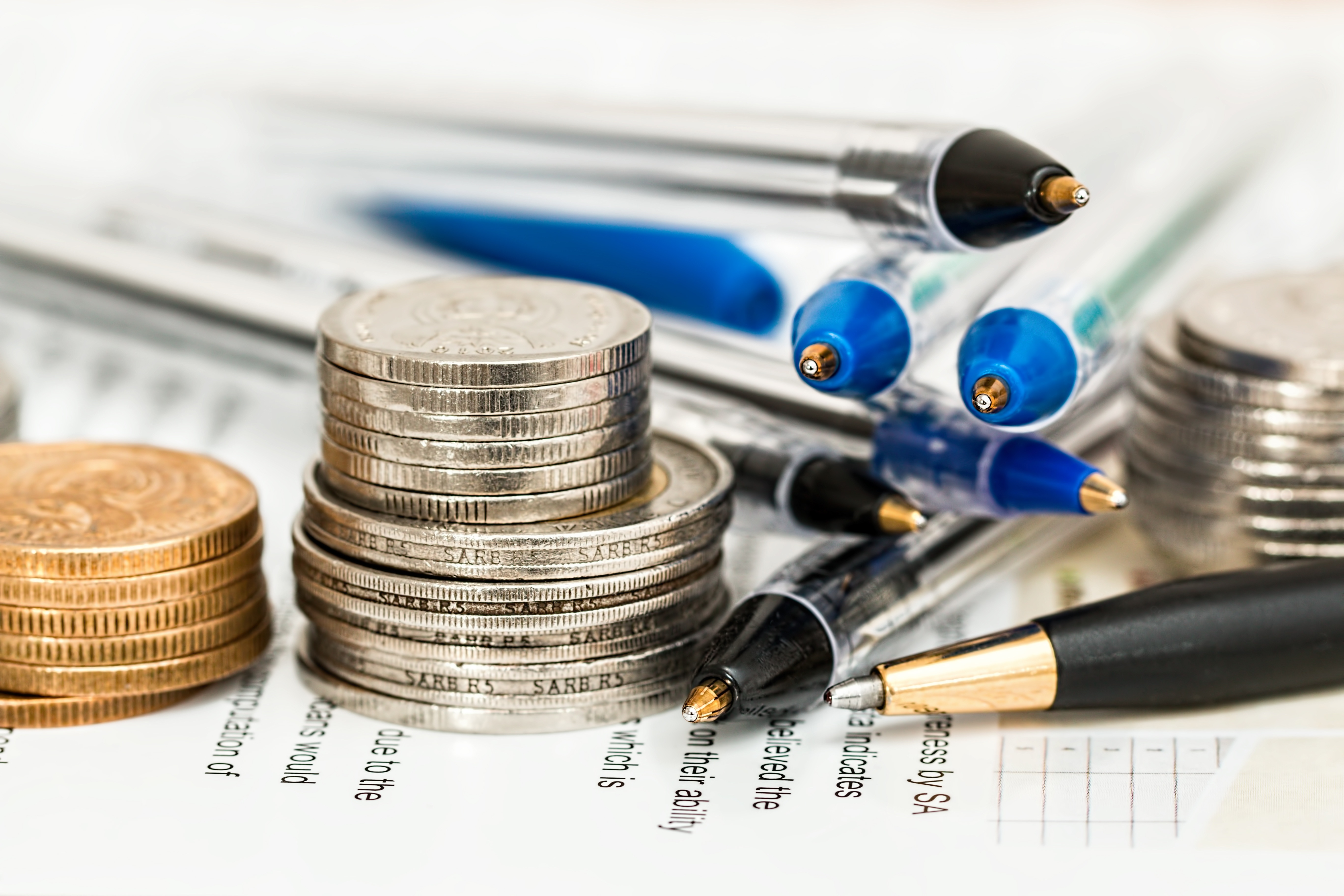 coins and pens on documents