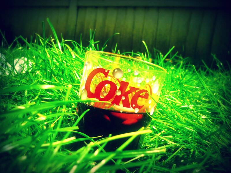 Coke glass in grass