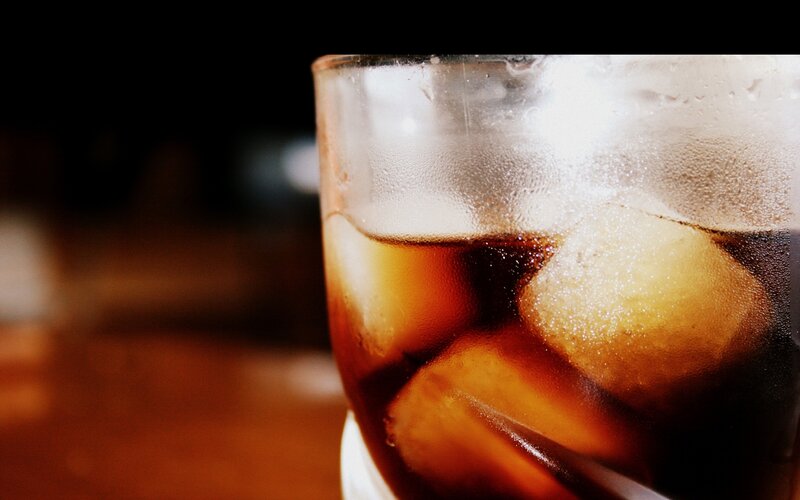 cold cola with ice cubes