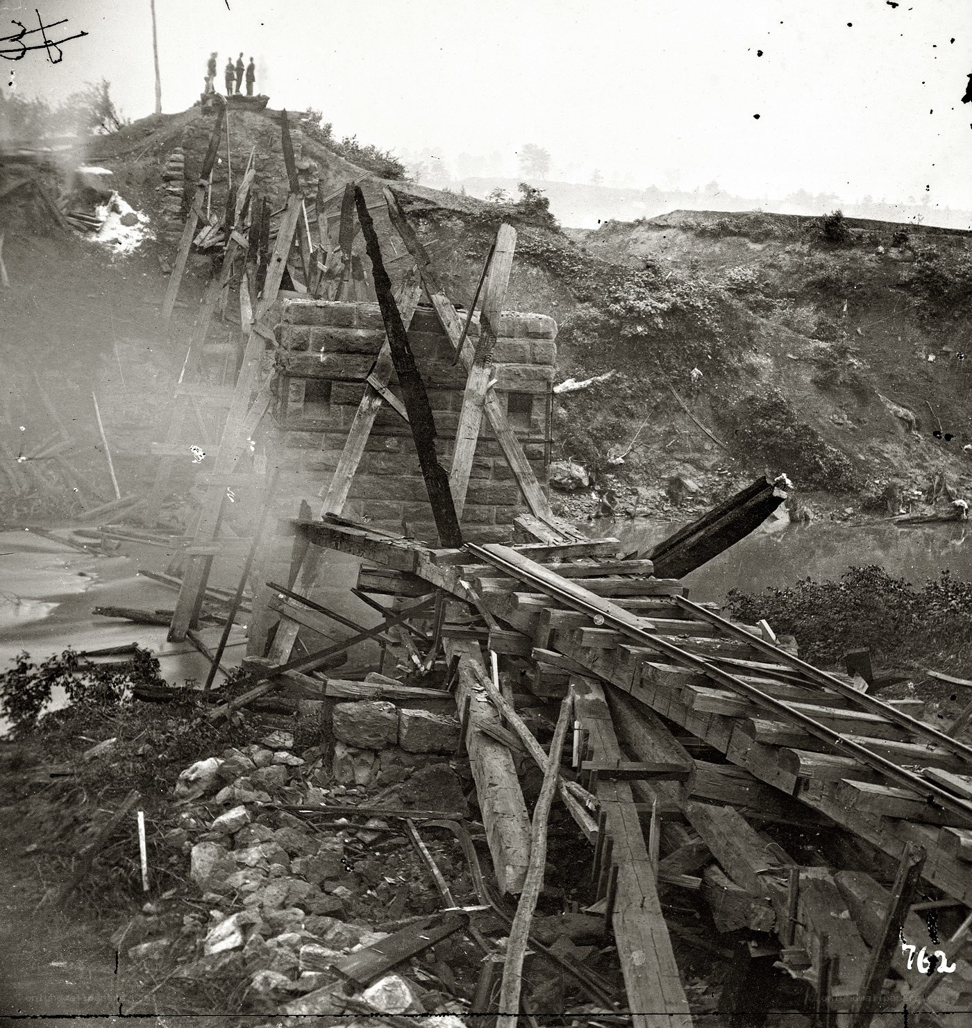 Collapsed bridge over river