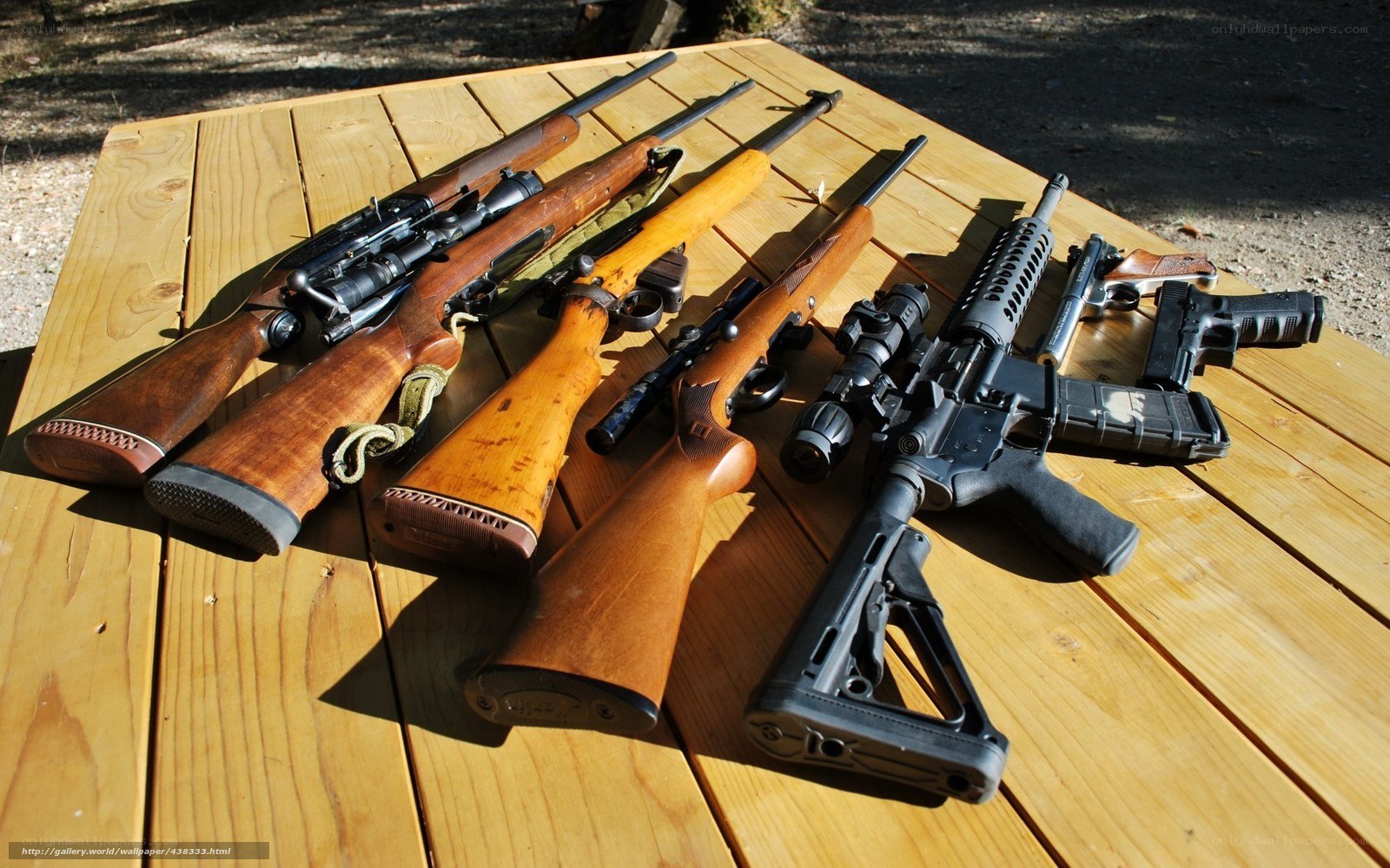 collection of firearms on table