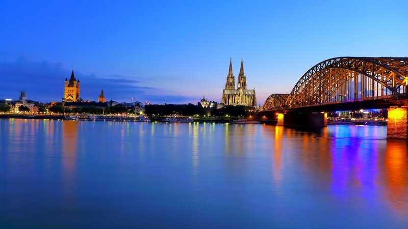 Cologne at dusk with cathedral and bridge