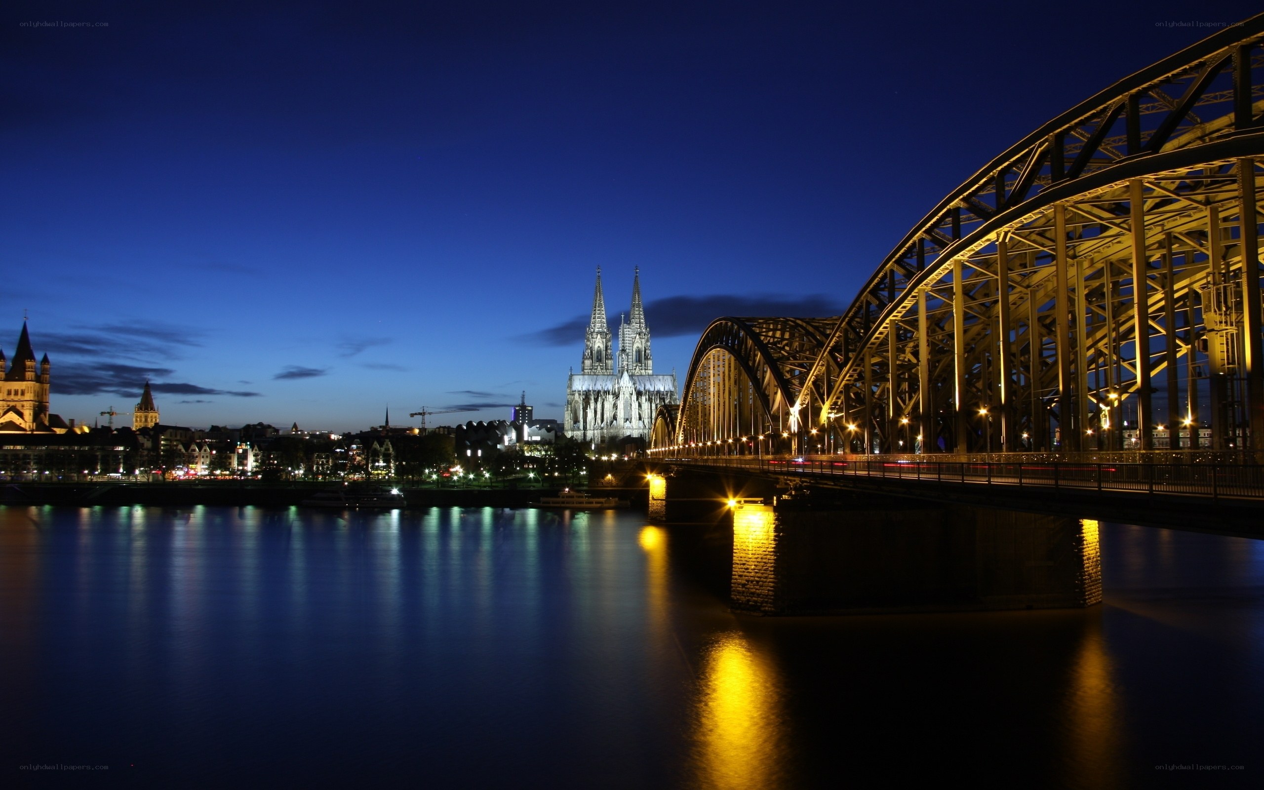Cologne at dusk with cathedral and bridge