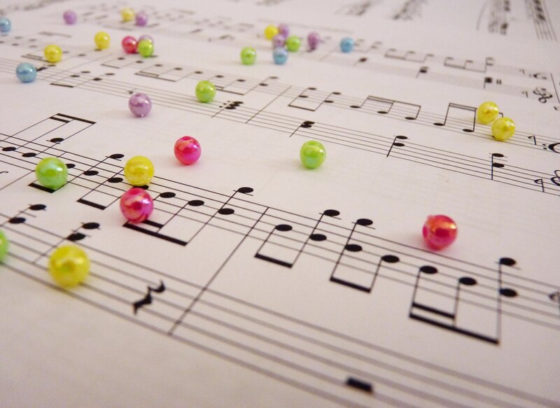 Colored Beads on Sheet Music