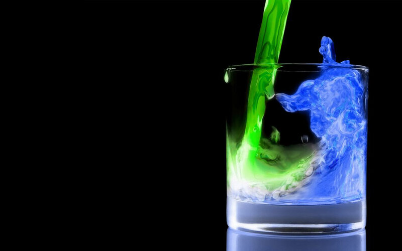 colored liquids mixing in glass