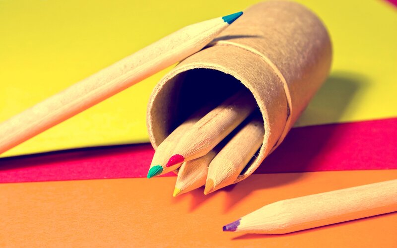 Colored pencils in a cardboard tube